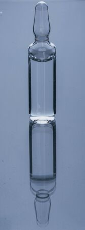 Glass medical ampoule vial for injection. Medicine is dry white drug penicillin powder or liquid...