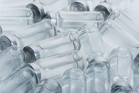 Glass medical ampoule vial for injection. Medicine is dry white drug penicillin powder or liquid...