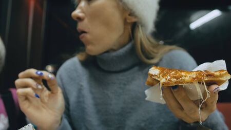 Girl eat pizza cheese four. Close up of young woman mouth greedily eating pizza and chewing in...