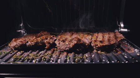 Delicious juicy meat steak cooking on grill. Aged prime rare roast grilling tenderloin fresh marble...
