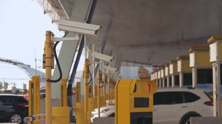 Antibacterial and antiviral treatment of toll roads in Thailand. Spraying chemical fluid over cars....