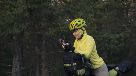 The woman travel on mixed terrain cycle touring with bike bikepacking outdoor. The traveler journey...