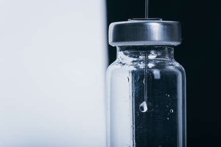 Medicine, Injection, vaccine and disposable syringe, drug concept. Sterile vial medical syringe needle. Glass medical ampoule vial for injection.の写真素材