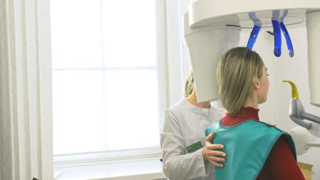Doctor to take a image 3dx-ray machine 3d digital scanner tomography of teeth and jaw in modern...