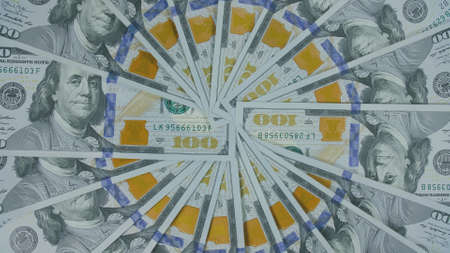 Many dollar are arranged around the edges of the image as a frame. Money create pattern, make design...