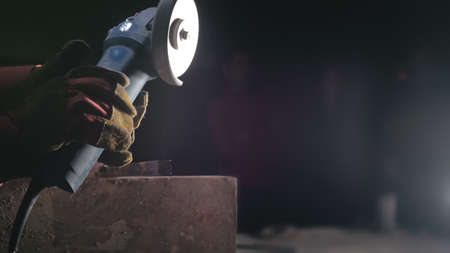 Forge workshop. Smithy manual production. Close up details of sparks, industrial worker using angle...