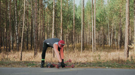 Training an athlete on the roller skaters. Biathlon ride on theの写真素材