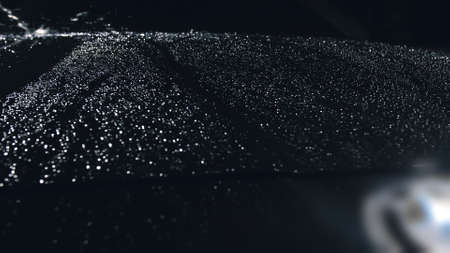 Drop flow down the hood. Close up view of bonnet car. Dark black cinematic picture. Process stage of polishing and washing auto. Hose is poured water.の写真素材