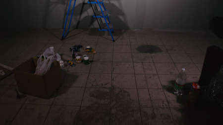 Artist designer draws an eagle on the wall. Craftsman decorator paints a picture with acrylic oil color. Painter painter dressed in a paint coat.の写真素材