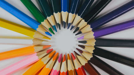 Many colored pencils are arranged around the edges of the imageの写真素材