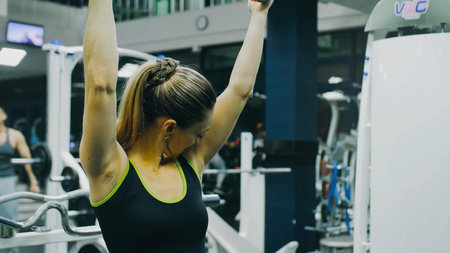 Fit Athletic Woman Exercises with Dumbbell. Bodypositive Girl with Beautiful Hairy Armpits. Sweat smell.の写真素材