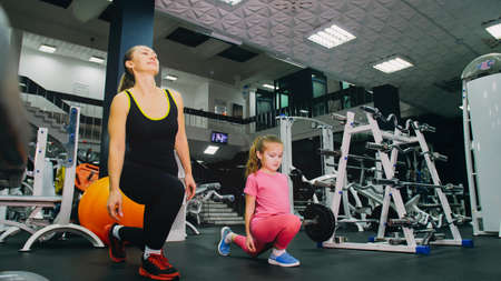 Mother and Daughter in the Gym, Family Performs Physical doing Eの写真素材