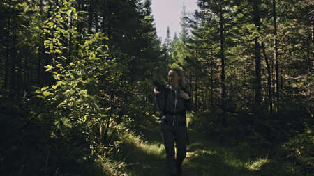 Traveler photographing scenic view in forest. One caucasian woman shooting nice magic look. Girl...