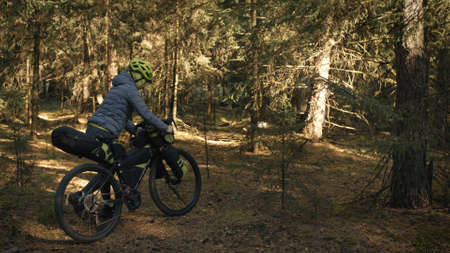 The woman travel on mixed terrain cycle touring with bike bikepacking. The traveler journey with...