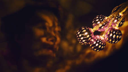 Magic hot light from lanterns falls on the woman eyes. The naked adult sexy caucasian girl lies at...