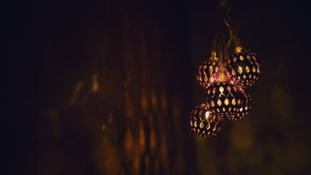 Magic lanterns spin and give beautiful glare to the walls. New Year glowing balls with led diodes are held in hands. Warm lamp light christmas mood.の写真素材