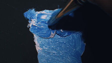 Artist copyist paint seascape with ship in ocean. Craftsman decorator draw as boat sail on blue sea with acrylic oil color. Draw finger, brush, knife.の写真素材