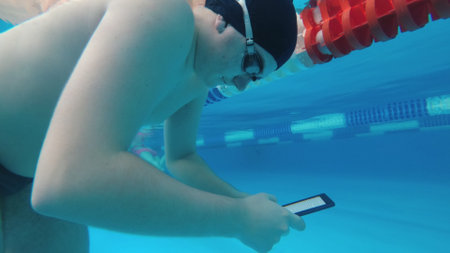 The guy is reading an electronic book underwater.の写真素材