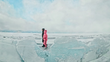 Couple has fun during winter walk against background of ice of fの写真素材