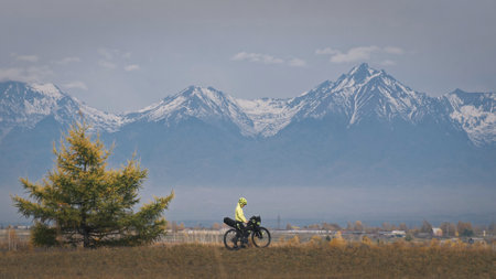 The woman travel on mixed terrain cycle touring with bikepacking. The traveler journey with bicycle bags. Sport tourism bikepacking.の写真素材