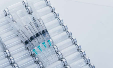 Medicine, Injection, vaccine and disposable syringe, drug concept. Sterile vial medical syringe needle. Glass medical ampoule vial for injection.の写真素材