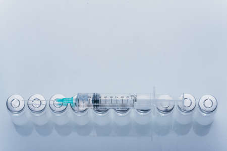 Medicine, Injection, vaccine and disposable syringe, drug concept. Sterile vial medical syringe needle. Glass medical ampoule vial for injection.の写真素材