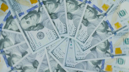 Many dollar are arranged around the edges of the image as a fram