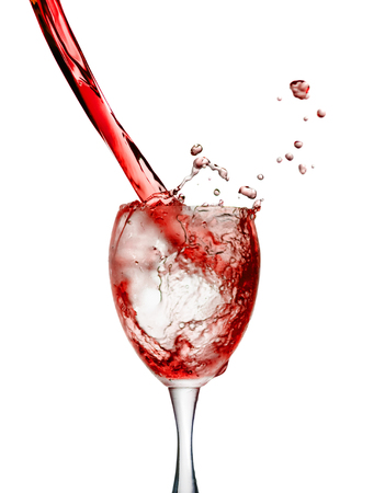 Red wine poured in a glass isolated on white backgroundの写真素材