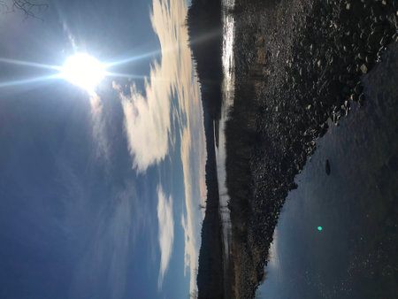 Reflection of the sun in the water of a river in winter