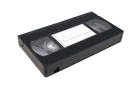 Videocassette black laying on a white background with a label for inscriptions.の写真素材