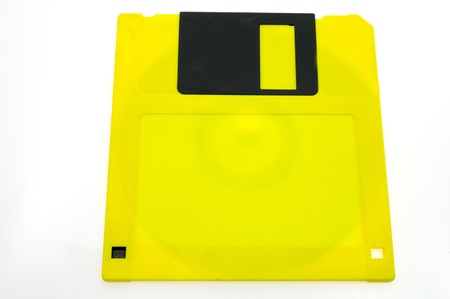 One yellow diskette isolated on white backgroundの写真素材