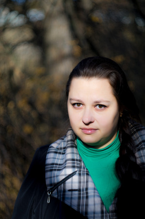 The woman with beautiful eyes in the autumn in park.の写真素材