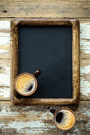 Coffee cups on vintage menu boardの写真素材