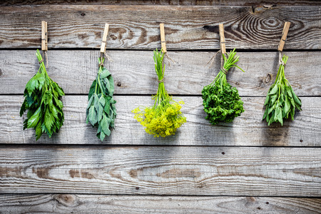 Herbs hanging over wooden backgroundの写真素材