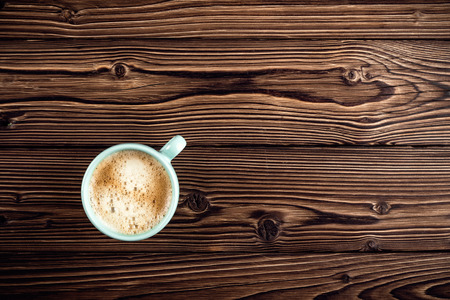coffee cup on wooden background top viewの写真素材