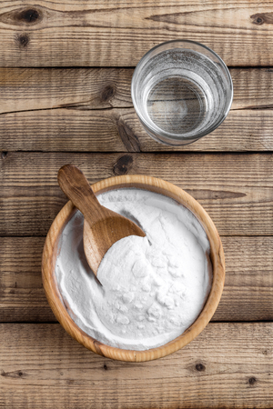 baking soda in bowl on wooden table top viewの写真素材