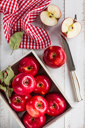 red apples on white wooden table top viewの写真素材