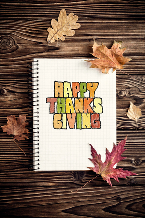 thanksgiving card with autumn leaves and notepadの写真素材