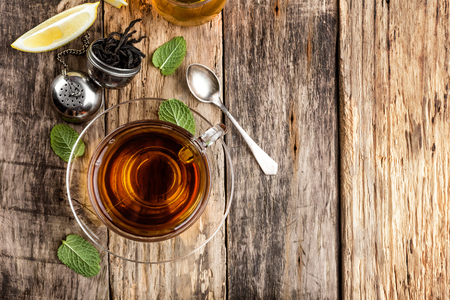 Black tea with lemon and mintの写真素材