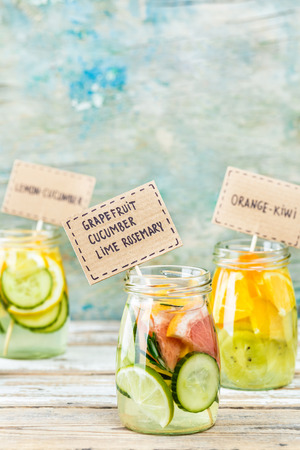 Variety of fruit infused detox water in jars for a healthy dietの写真素材