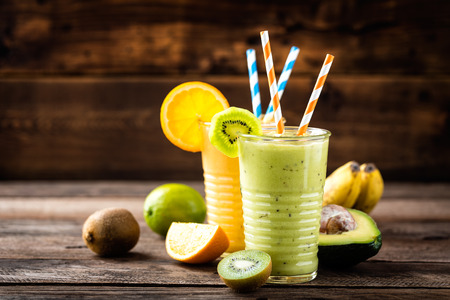 orange and green smoothies with exotic fruits, healthy eating, superfoodの写真素材