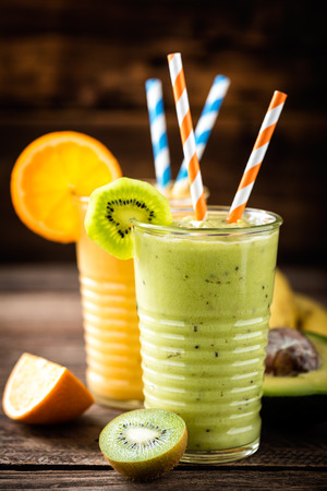 orange and green smoothies with exotic fruits, healthy eating, superfoodの写真素材