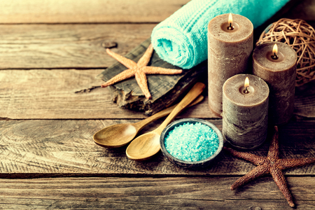 Set for spa treatments with cosmetic products for body care and relaxation on wooden background with space for a textの写真素材
