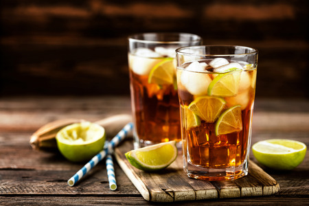 Cuba Libre or long island iced tea cocktail with strong drinks, cola, lime and ice in glass, cold longdrinkの写真素材