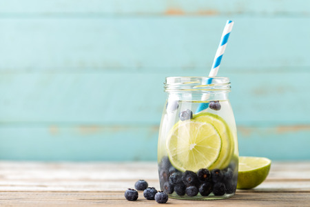 infused detox water with lime and blueberry for diet healthy eating and fat burning with space for a textの写真素材