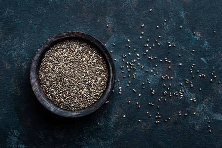 Chia seeds in a stone bowl on a dark backgroundの写真素材
