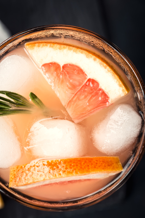 Grapefruit and rosemary gin cocktail or margarita, refreshing drink with iceの写真素材