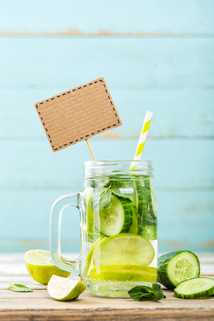 infused detox water with cucumber, lime and mint for diet healthy eating and weight loss with blank space for your textの写真素材