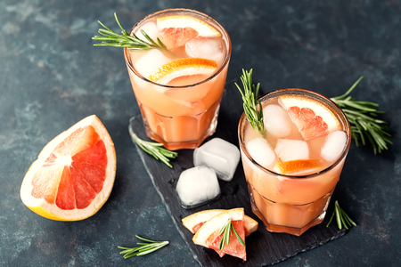 Grapefruit and rosemary gin cocktail or margarita, refreshing drink with iceの写真素材