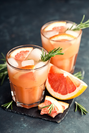 Grapefruit and rosemary gin cocktail or margarita, refreshing drink with iceの写真素材